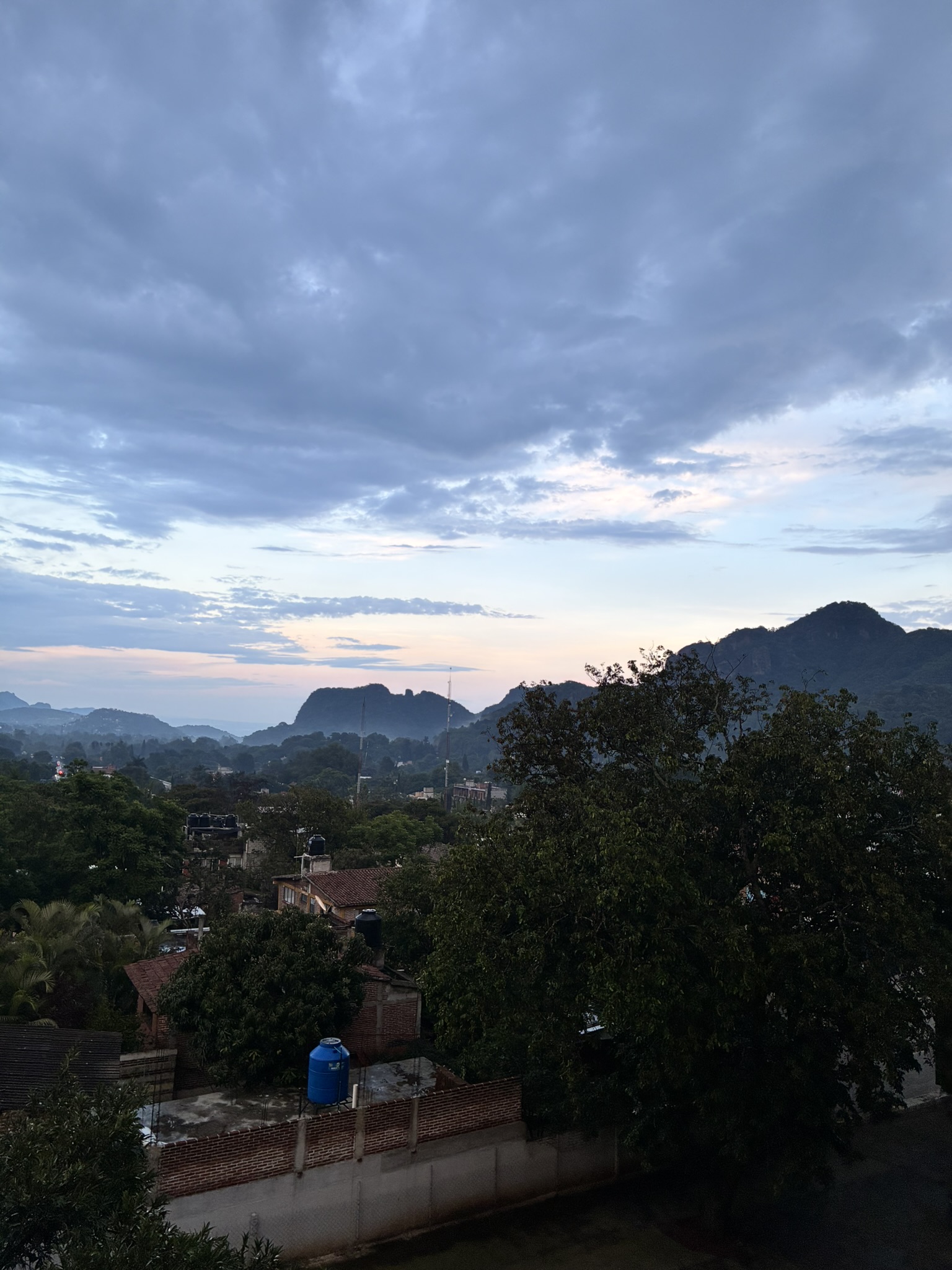 Sunset over Tepoztlán with the mountain silhouette and rooftops in view